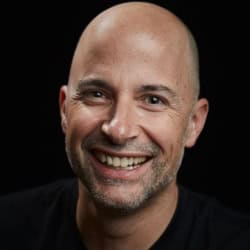 Man smiling, embracing community and spirituality in psychedelic healing.